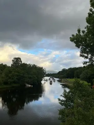 a river with boats in the water and trees at Modern 3 Bed Flat Balloch in Jamestown