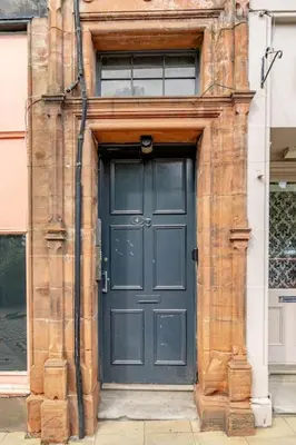 a blue door on a building with a window at Spacious City Apt - Dunfermline in Fife