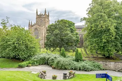 an old building with a clock tower in a park at Spacious City Apt - Dunfermline in Fife
