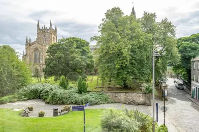 a view of a park with a cathedral in the background at Spacious City Apt - Dunfermline in Fife