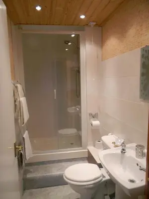 a bathroom with a shower and a toilet and a sink at Harbour Lights Guesthouse in Stranraer