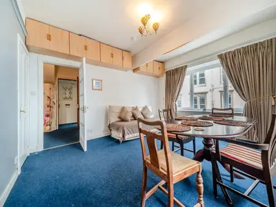 a living room with a table and a couch at Bay View in Oban