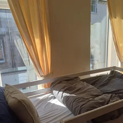 a bed in a room with a window at Bay View in Oban