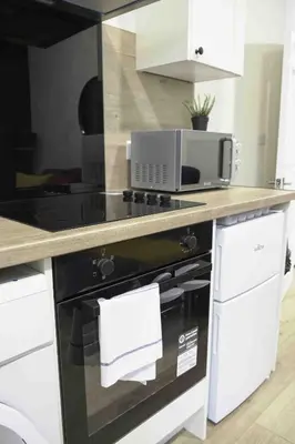 a kitchen with a stove and a microwave at Braelochan Stay in Balloch
