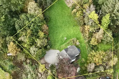 an overhead view of a field with a house and trees at Bruach in Balquhidder