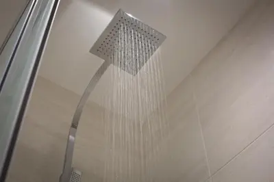 a shower with a shower head in a room at Penthouse Apartment at Loch Lomond with 2 bedrooms in Balloch