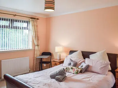 a bedroom with a bed and a window at Wallace View in Stirling