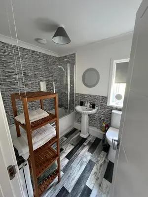 a bathroom with a shower and a sink at Elro House Holiday Let in Tillicoultry