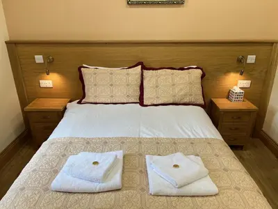 a bedroom with a bed with two towels on it at Cumberland Hotel in Edinburgh