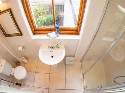 a bathroom with a sink and a window at Cumberland Hotel in Edinburgh