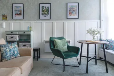 a living room with a couch and a table at Carvetii - Meg's Studio - 1st Floor, Dunfermline City Centre in Dunfermline