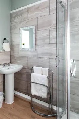 a bathroom with a glass shower and a sink at Carvetii - Meg's Studio - 1st Floor, Dunfermline City Centre in Dunfermline