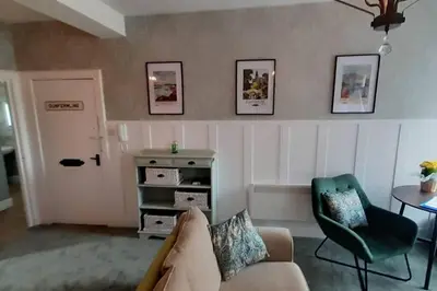 a living room with a couch and a table at Carvetii - Meg's Studio - 1st Floor, Dunfermline City Centre in Dunfermline