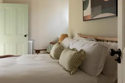 a white bed with four pillows on top of it at Montagu in Thornhill