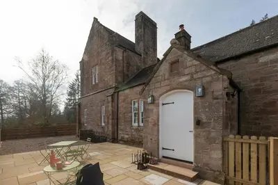 an old brick building with a white door and a patio at Montagu in Thornhill