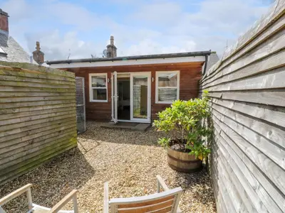 a bedroom house with a garden in front of it at The Suite in Thornhill