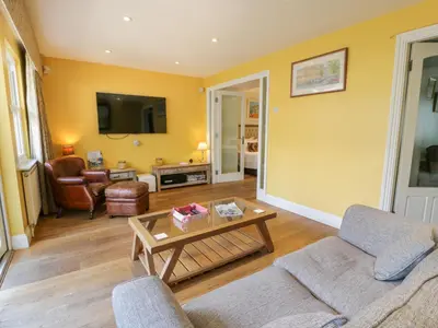 a living room with a couch and a table at The Suite in Thornhill