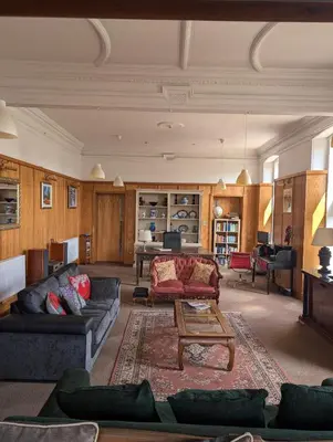 a living room with a couch and a table at Garmoyle House & Garmoyle Mid Cottage in Dumbarton