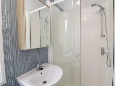 a bathroom with a sink and a shower at Ash in Denny