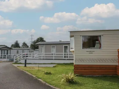 a mobile home with a window on the side of it at Yew in Denny