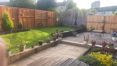 a backyard with a garden with potted plants at Frans Place in Edinburgh