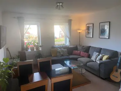 a living room with a couch and a guitar at Frans Place in Edinburgh