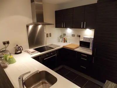 a small kitchen with a sink and a microwave at Violet Bank Apartment New Town in Edinburgh
