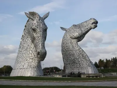 two statues of two horses standing next to each other at Holly in Denny