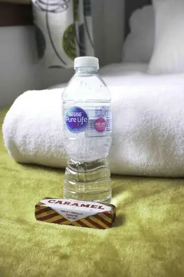 a bottle of water sitting next to a packet of butter at Redding House in Falkirk