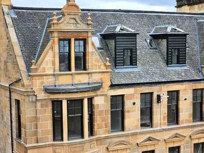 an old brick building with windows and a roof at 6 Smithhills - Sleeps 3 Central Excellent Transport Links Glasgow & Airport in Paisley