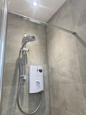 a shower with a shower head in a bathroom at 6 Smithhills - Sleeps 3 Central Excellent Transport Links Glasgow & Airport in Paisley