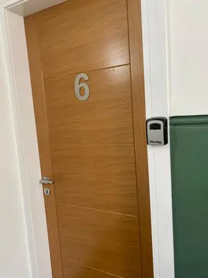 a wooden door with the number six on it at 6 Smithhills - Sleeps 3 Central Excellent Transport Links Glasgow & Airport in Paisley