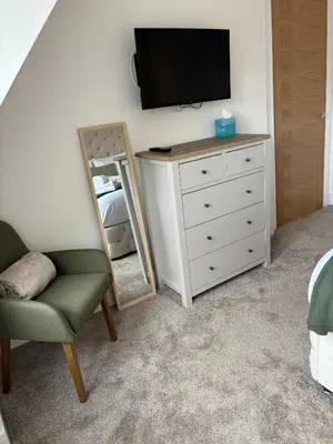 a bedroom with a dresser and a tv and a mirror at 6 Smithhills - Sleeps 3 Central Excellent Transport Links Glasgow & Airport in Paisley