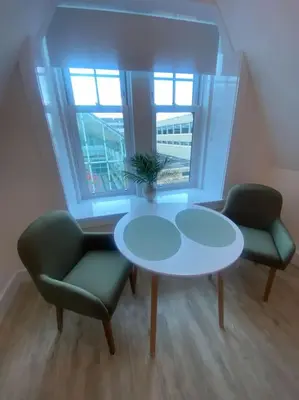 a room with a table and two chairs and a window at 5 Smithhills Paisley Central GLW & Glasgow access in Paisley