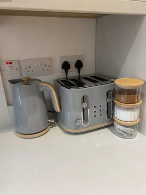 a kitchen with two toasters and a toaster at 5 Smithhills Paisley Central GLW & Glasgow access in Paisley