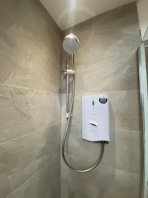 a shower with a shower head in a bathroom at 5 Smithhills Paisley Central GLW & Glasgow access in Paisley