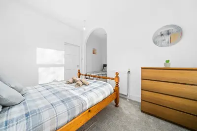 a bedroom with a bed with a teddy bear on it at Charming 1-Bedroom Home in Alexandria in Alexandria