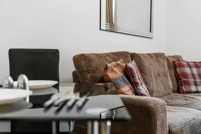 a living room with a couch and a table at Charming 1-Bedroom Home in Alexandria in Alexandria