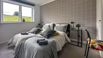 a bedroom with two beds and a window at Brand New Scotland home 3rooms near Glasgow in Clydebank