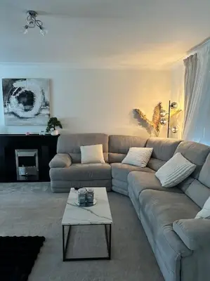 a living room with a couch and a coffee table at 3 double bedroom spacious flat in Largs