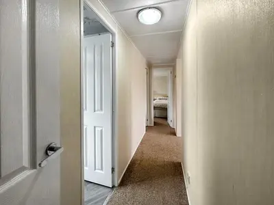 a hallway with a door leading to a bedroom at Lisset in Newton Stewart