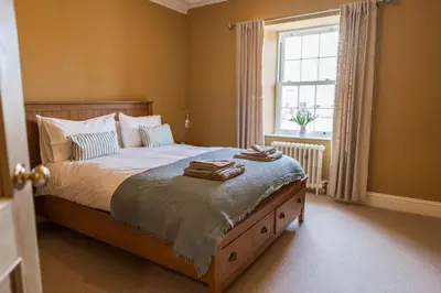 a bedroom with a bed with two towels on it at Rosebank Cottage - Hot Tub & Log Stove in Alexandria