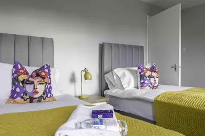 a room with two beds and avisor at Pentland House in Bathgate