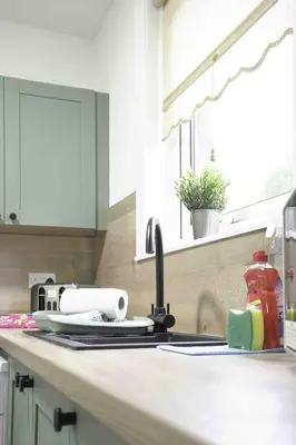 a kitchen counter with a sink and a window at Pentland House in Bathgate