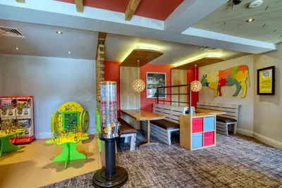 a childrens play room with a table and chairs at Queen of the Loch, Balloch by Marston's Inns in Balloch