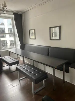 a living room with a table and a bench at Central Morrison Street Apartment in Edinburgh