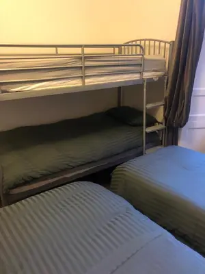 two bunk beds in a room with a bed at Central Morrison Street Apartment in Edinburgh