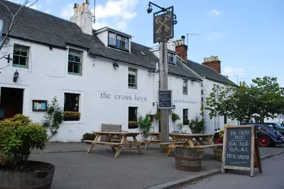 a group of picnic tables in front of a building at The Cross Keys in Kippen in Kippen