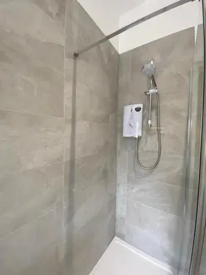 a shower with a glass door in a bathroom at 4 Smithhills Central 2 bed sleeps 4 in Paisley