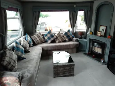 a living room with a couch and a fireplace at Cairnryan - Loch Ryan View in Cairnryan